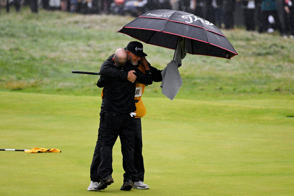 Brian Harman hugs his caddie after winning The 151st Open